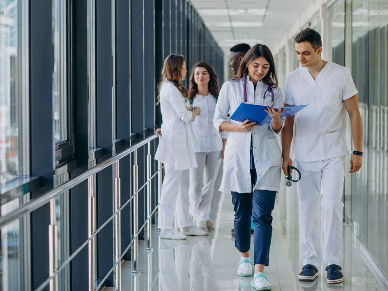team-of-young-specialist-doctors-standing-in-the-corridor-of-the-hospital
